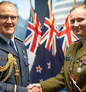 Chief of Defence Force Air Marshall Kevin Short presents Captain Bronwyn Flewellen with her meritorious service medal.