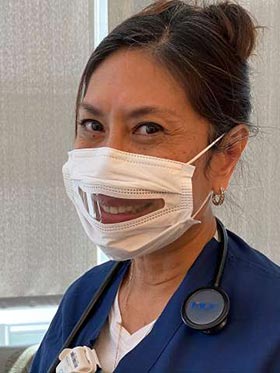 Nurse wearing clear face mask