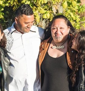 Portrait of a young Māori family taken outdoors