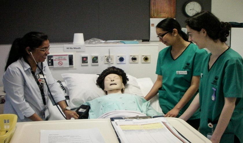 Simulation learning: Lecturer Omana Thomas using a mannequin to guide students on how to deal with a patient with chest pain.