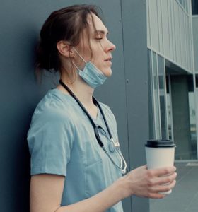 Exhausted nurse on a coffee break