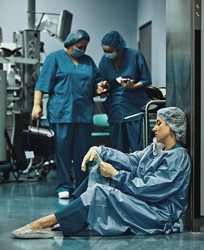 Exhausted nurses at the end of a shift in theatre PHOTO: ADOBE STOCK