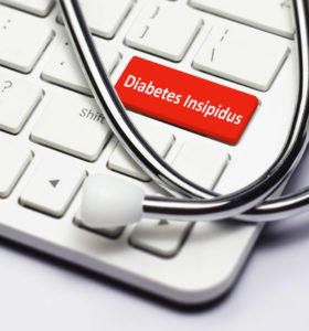 Diabetes Insipidus text, stethoscope lying down on the cumputer keyboard