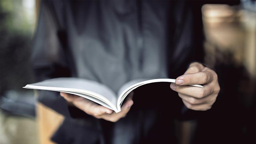 Closeup of person holding a diary. PHOTO: ADOBE STOCK