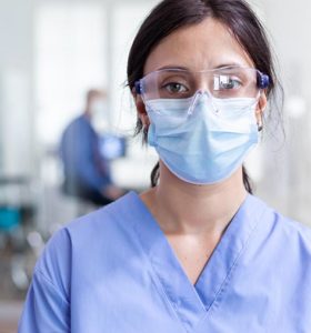 Nurse wearing a mask and safety glasses