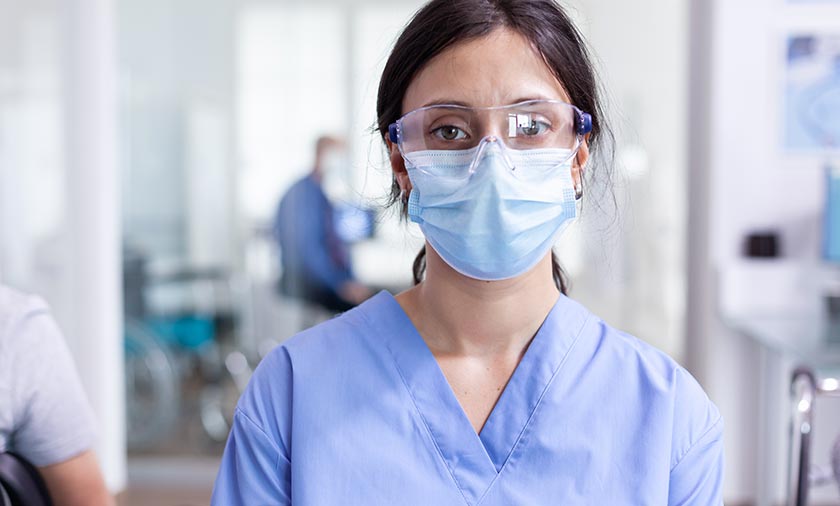 Nurse wearing a mask and safety glasses