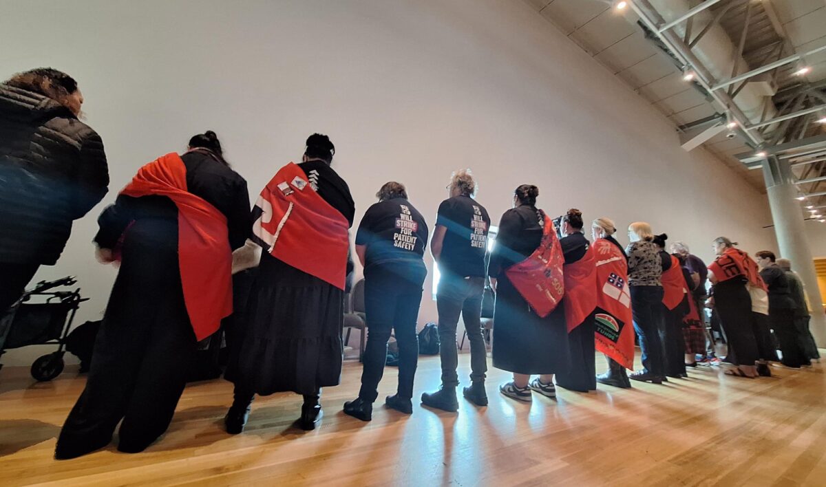 Health Minister Simeon Brown sees red, literally, as nurses turn their backs during NZNO AGM